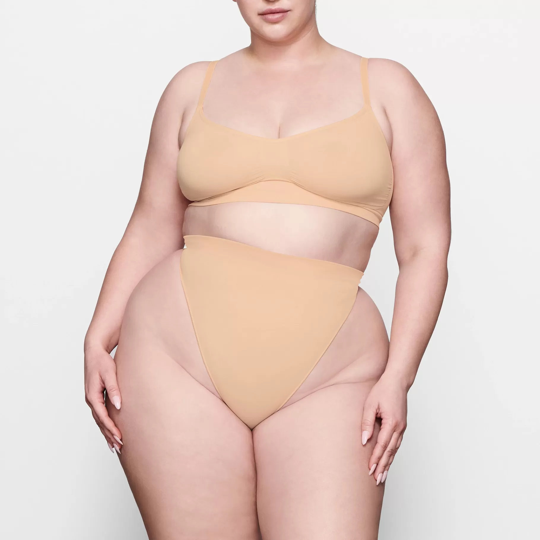 Skims shaping underwear*SEAMLESS SCULPT MID WAIST THONG | OCHRE